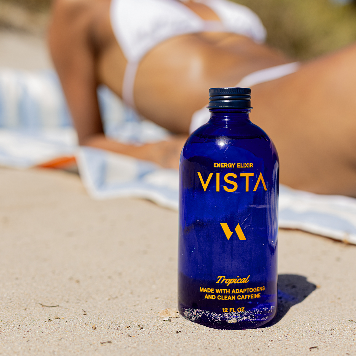 Vista Tropical bottle in the sand at the beach